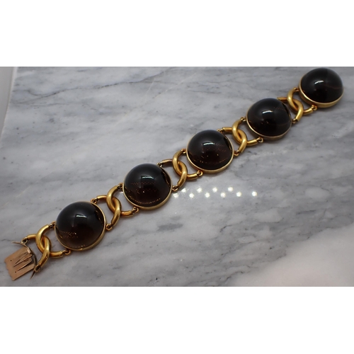 168 - A Bracelet having circular links each set large smoky quartz cabochons