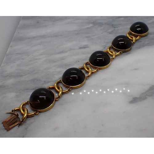 168 - A Bracelet having circular links each set large smoky quartz cabochons