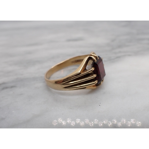 187 - A Garnet Ring claw-set step-cut stone in 9ct gold, ring size S