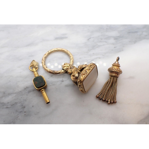 188 - A yellow metal Fob set onyx, a yellow metal Tassel Fob and a Watch Key set bloodstone and cornelian