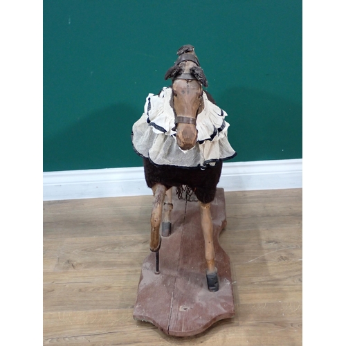 29 - An antique wool covered carved wooden and leather push along Horse on base 2ft 3in L x 2ft 2in H