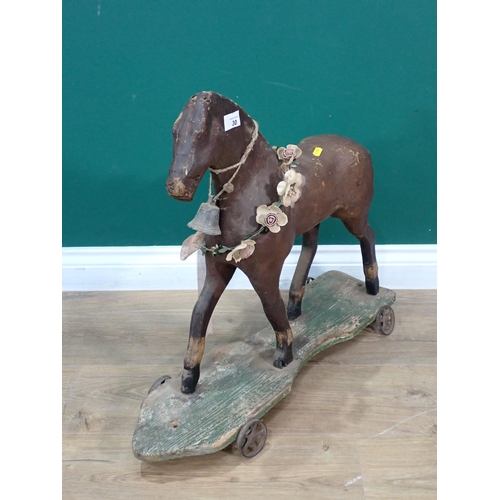 30 - An antique leather and wooden push along horse 2ft 2in L x 1ft 11in H