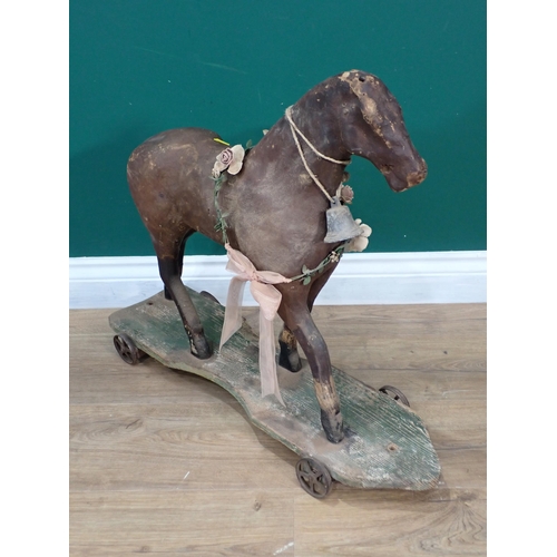 30 - An antique leather and wooden push along horse 2ft 2in L x 1ft 11in H