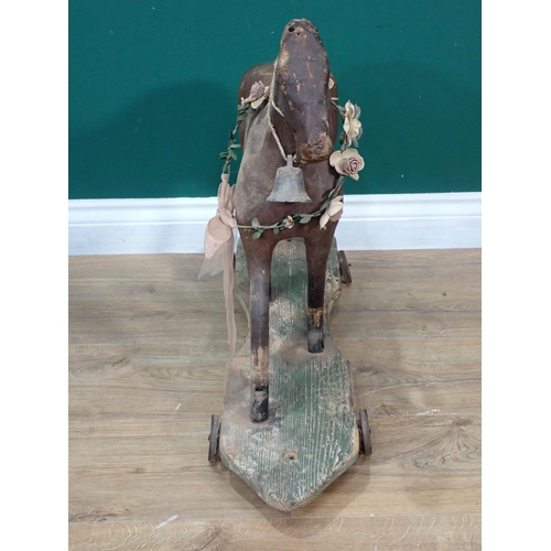 30 - An antique leather and wooden push along horse 2ft 2in L x 1ft 11in H