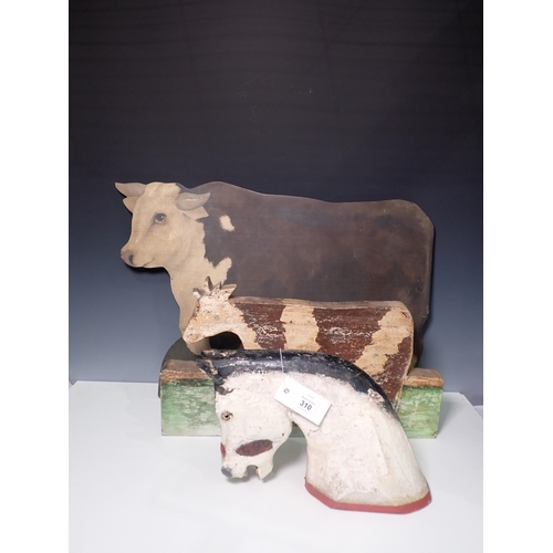 310 - An antique carved and painted Rocking Horse Head, a painted Screen in the form of a Hereford Cow and... 