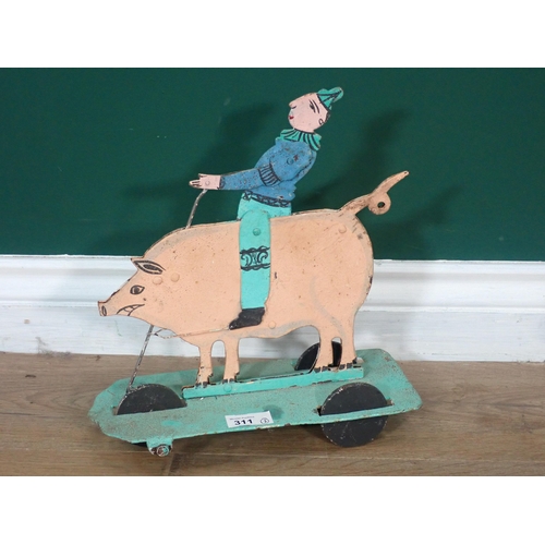 311 - A metal Door Stop in the form of a Cow and a Toy Clown riding a Pig