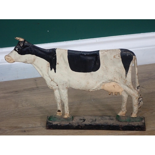 311 - A metal Door Stop in the form of a Cow and a Toy Clown riding a Pig