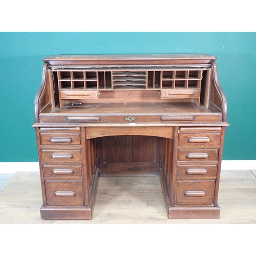 321 - An oak tambour fronted Desk fitted nine drawers 4ft 7in W x 3ft 11in H