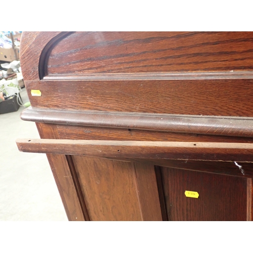 321 - An oak tambour fronted Desk fitted nine drawers 4ft 7in W x 3ft 11in H