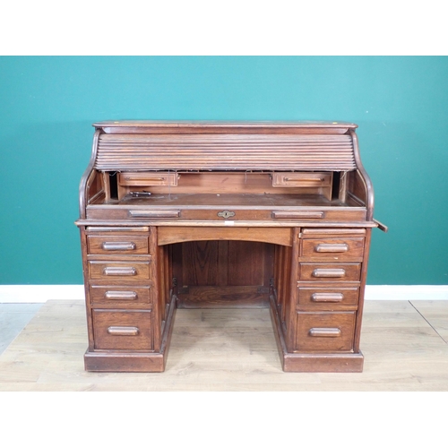 321 - An oak tambour fronted Desk fitted nine drawers 4ft 7in W x 3ft 11in H