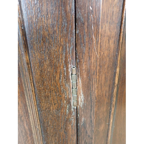 323 - An oak Hall Cupboard with canted corners and beaded and carved design fitted single door 6ft 6in H x... 