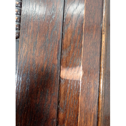 323 - An oak Hall Cupboard with canted corners and beaded and carved design fitted single door 6ft 6in H x... 