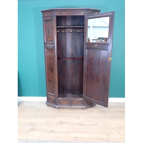 323 - An oak Hall Cupboard with canted corners and beaded and carved design fitted single door 6ft 6in H x... 