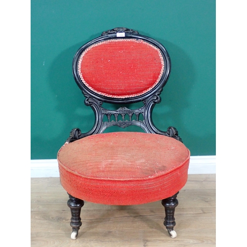 339 - A Victorian ebonised Nursing Chair with red upholstery