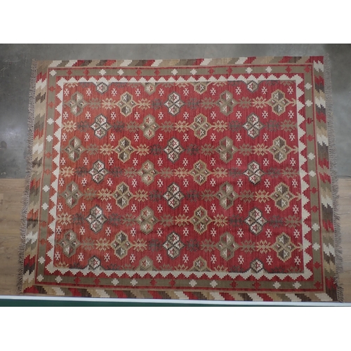 384 - An Oka Indian red ground Rug with bold geometric design 10ft 10in L x 8ft 5in W