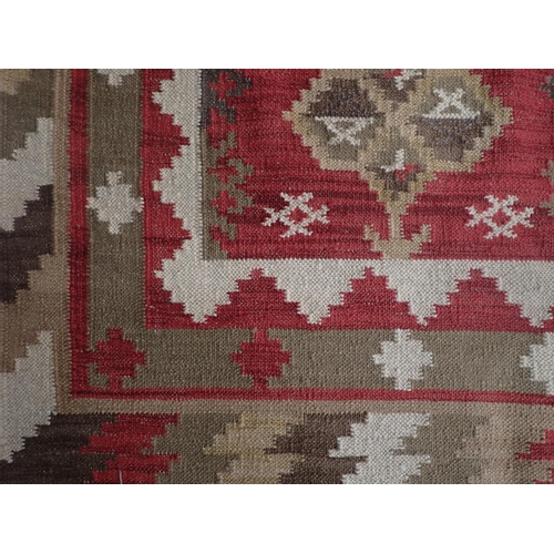 384 - An Oka Indian red ground Rug with bold geometric design 10ft 10in L x 8ft 5in W