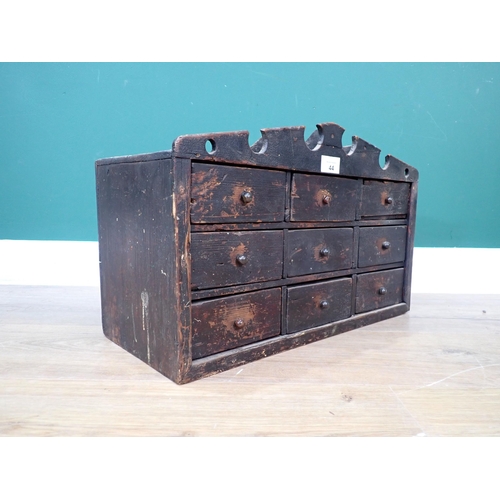 44 - A Victorian painted pine small bank of nine drawers with shaped cornice 1ft 7in W x 1ft H