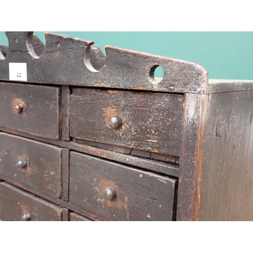 44 - A Victorian painted pine small bank of nine drawers with shaped cornice 1ft 7in W x 1ft H