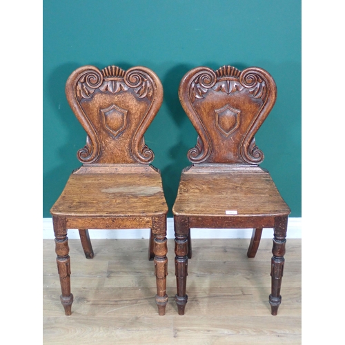 483 - A pair of Victorian oak Hall Chairs with carved scrolled backs