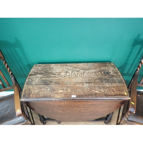 485 - An oak Gateleg Dining Table on barley twist supports 3ft 6in W x 2ft 4in H and a pair of Elbow Chair... 