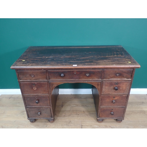 487 - A Victorian mahogany Kneehole Desk fitted nine drawers mounted on bun feet 4ft 3in W x 2ft 9in H