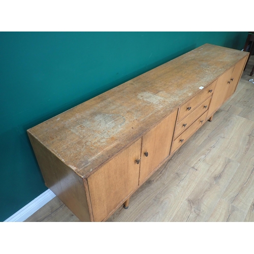 528 - A mid-century oak Sideboard fitted four cupboard doors flanking three drawers in the manner of Heals... 