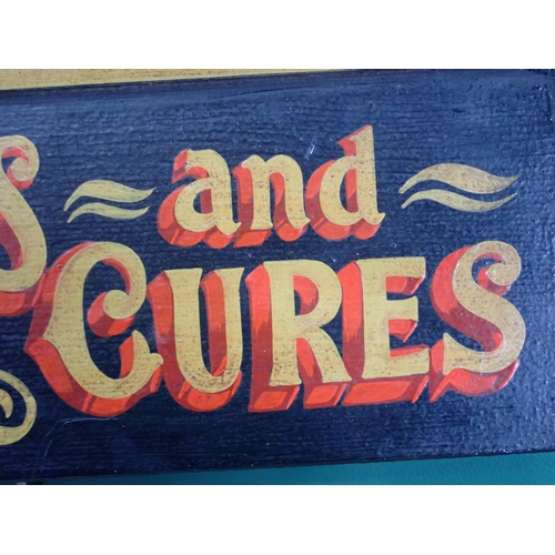 545 - A wooden hand 
painted Sign 'Remedies and Cures' 1ft 4in W x 7in H