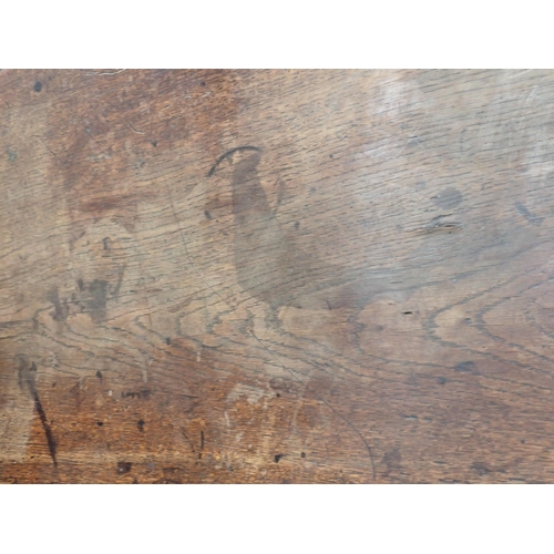 557 - An antique oak oak oval dropleaf Dining Table mounted on square cut supports 3ft 9in W x 2ft 6in H