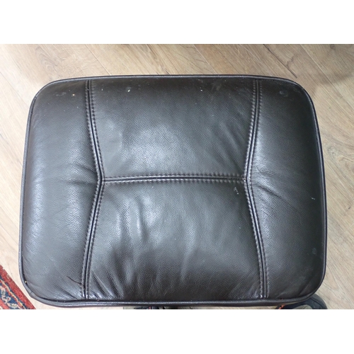 558 - A brown leather effect swivel Easy Chair and Foot Stool