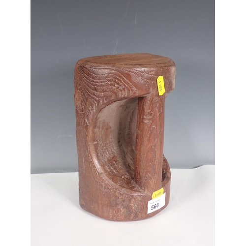 566 - A carved teak Doorstop