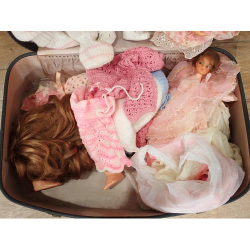 577 - A suitcase containing various Dolls