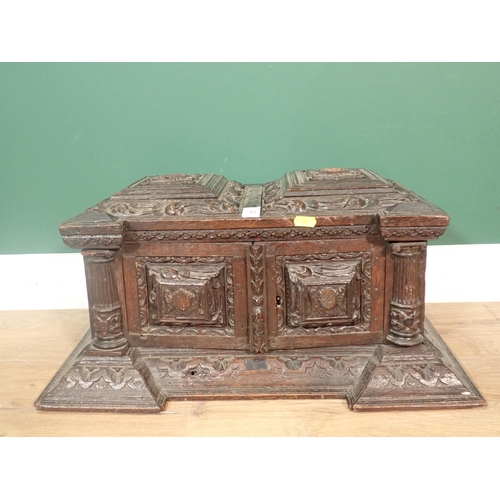 63 - A 19th Century Continental carved oak Casket fitted pair of cupboard doors enclosing pigeon holes A/... 