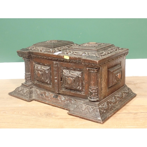 63 - A 19th Century Continental carved oak Casket fitted pair of cupboard doors enclosing pigeon holes A/... 