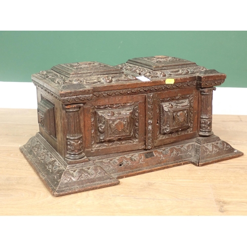 63 - A 19th Century Continental carved oak Casket fitted pair of cupboard doors enclosing pigeon holes A/... 