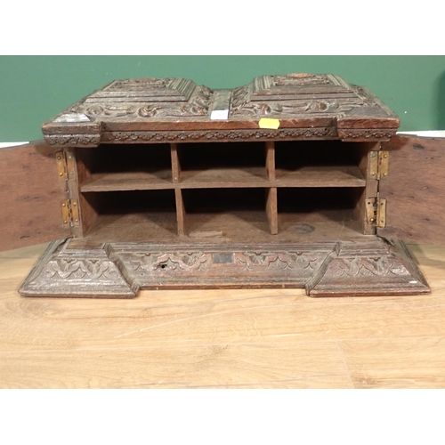 63 - A 19th Century Continental carved oak Casket fitted pair of cupboard doors enclosing pigeon holes A/... 