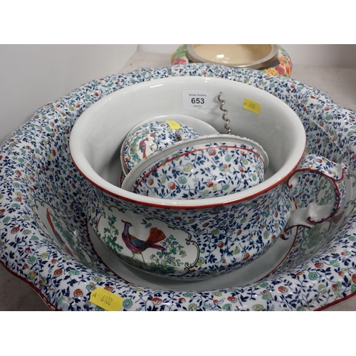 653 - A part Toilet Set decorated exotic birds and a Clarice Cliff Bowl moulded flowers