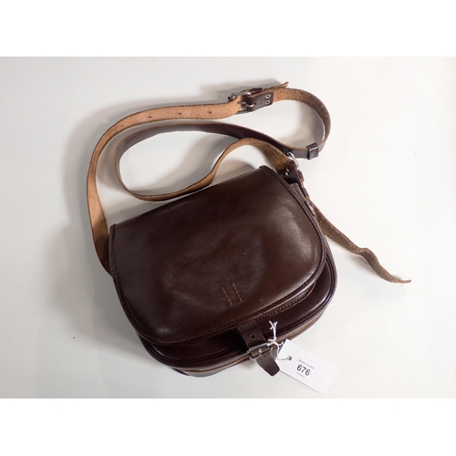 676 - A leather Cartridge Bag with front and inner pockets