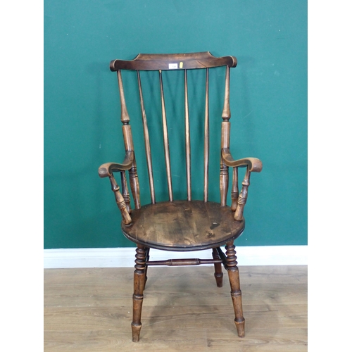 720 - An antique stick back Kitchen Armchair 3ft 7in H x 2ft W