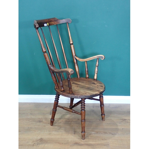 720 - An antique stick back Kitchen Armchair 3ft 7in H x 2ft W