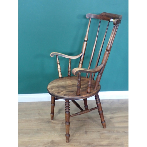 720 - An antique stick back Kitchen Armchair 3ft 7in H x 2ft W