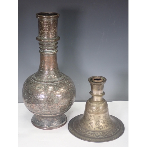 769 - An Eastern white metal Vase and an engraved Candlestick