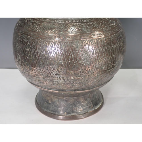 769 - An Eastern white metal Vase and an engraved Candlestick