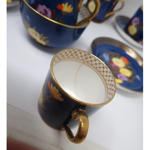 82 - A Crown Staffordshire Coffee Service for six, plus Jug and Bowl with bright floral design on a powde... 