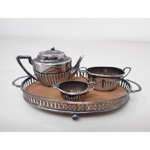 89 - An Edward VII miniature silver three piece Tea Service of oval fluted form, on a gallery Tray, Birmi... 