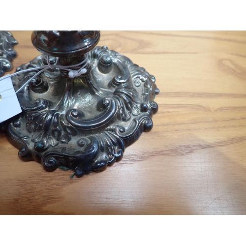 77 - A pair of George III silver Candlesticks with scroll decoration and engraved cockerel crests, Sheffi... 