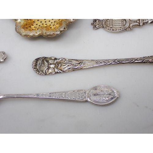 127 - A silver-gilt Spoon with mask and bird decoration, two silver Shooting Spoons, a Pusher, a Toddy Lad... 