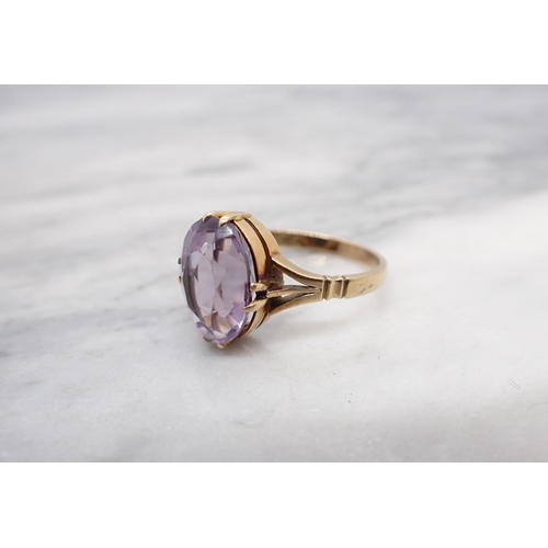 162 - An Amethyst Ring claw-set oval-cut stone, stamped 18ct, ring size M 1/2