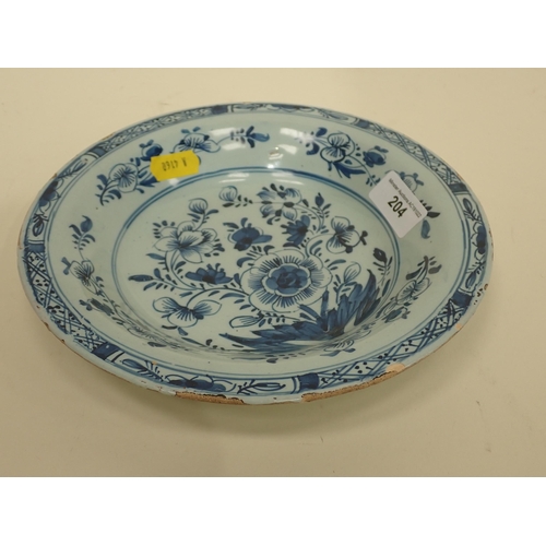 204 - A small 19th Century Delft Dish, decorated floral designs, 7 3/4in diam.