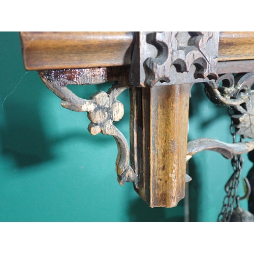 25 - A Black Forest type oak Cuckoo Clock with arched top and with pine cone weights and carved pendulum,... 