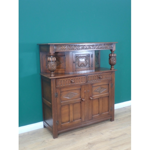 303 - A reproduction oak Court Cupboard in the 17th Century style fitted three carved panel doors and two ... 